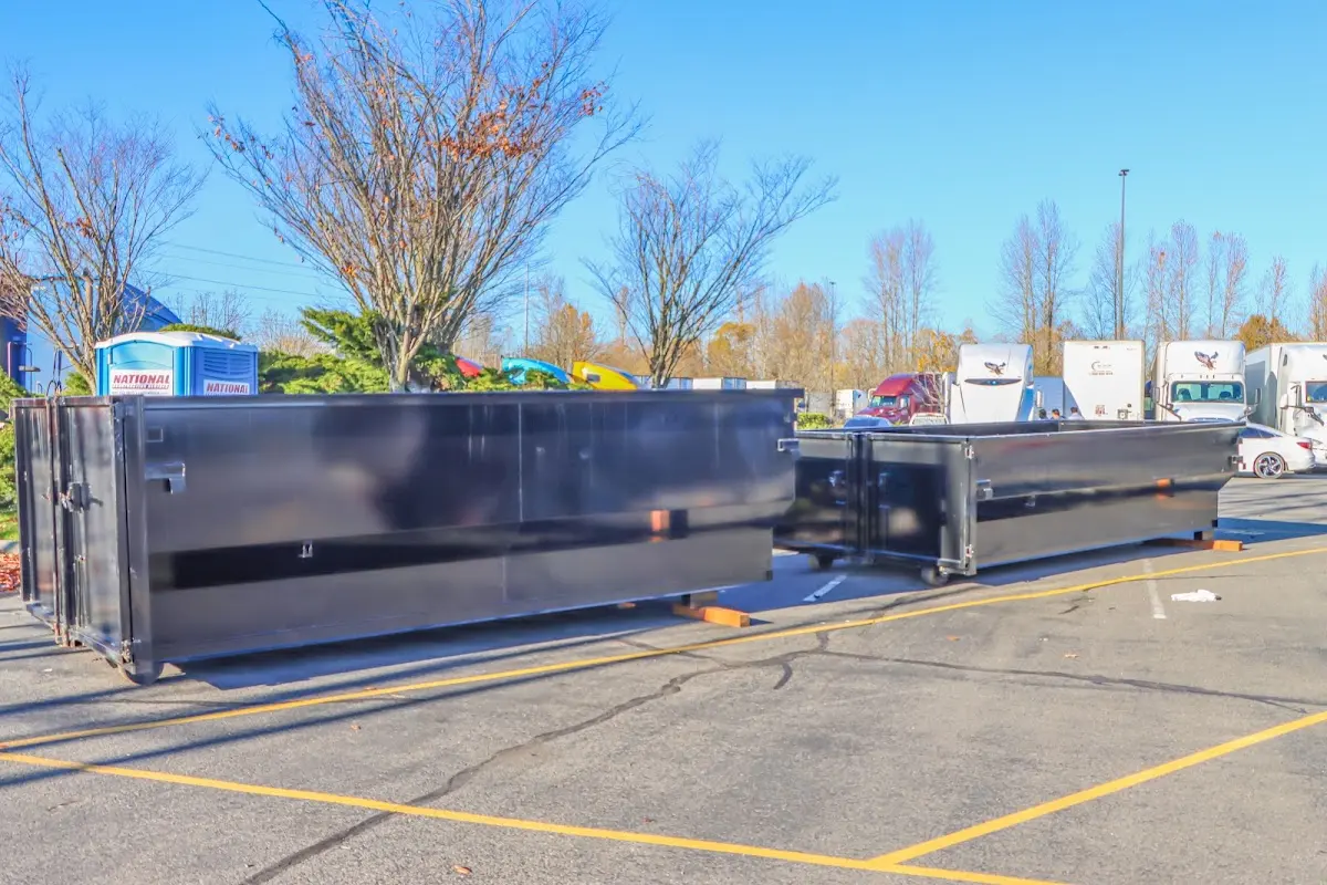 Professional dumpster rental service with roll-off container on residential driveway in Putnam